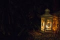 White lamp with burning flame on street steps. Lantern in the evening garden in Asia. Romantic decoration. Outdoor illumination.