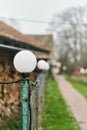 White lamp on the fence in the village Royalty Free Stock Photo