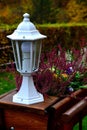 White lamp on the railing with autumn flowers, Sirakov, 29.10.2020, Czech Republic Royalty Free Stock Photo