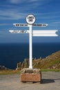 White Land's end directional sign over sea