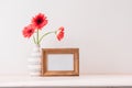 White landscape frame mock up with a vase of gerbera beside the frame Royalty Free Stock Photo