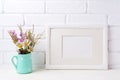 White landscape frame mockup with chamomile and purple flowers i Royalty Free Stock Photo