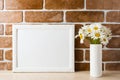 White landscape frame mockup with daisy bouquet in styled vase Royalty Free Stock Photo