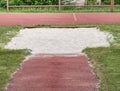 White lane for the long jump. Sandy red retrack white ake-off board Royalty Free Stock Photo