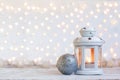 White lantern with candle and silver ball - Christmas decoration. Royalty Free Stock Photo