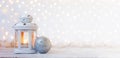 White lantern with candle and silver ball - Christmas decoration. Banner. Royalty Free Stock Photo