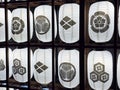 The white lanterns are printed with the family crests of Japanese Sengoku shoguns. Japanese Sengoku shoguns Kamon. Royalty Free Stock Photo