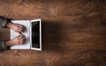 White laptop on a dark wooden desktop