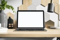 White laptop screen on wooden designer desktop