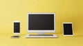 A white laptop sits on a yellow surface with three cell phones and two tablets Royalty Free Stock Photo