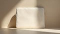 White laptop sleeve on beige background with soft natural light and shadow. Premium bag with zip closure on simple studio surface Royalty Free Stock Photo