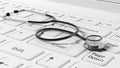 White laptops keyboard with a stethoscope