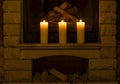 White large candles standing on the fireplace. Royalty Free Stock Photo