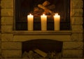 White large candles standing on the fireplace. Royalty Free Stock Photo