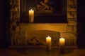 White large candles standing on the fireplace. Royalty Free Stock Photo