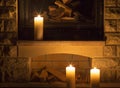 White large candles standing on the fireplace. Royalty Free Stock Photo