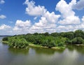 White large clouds over the river and trees. Royalty Free Stock Photo