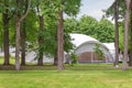 White large luxury glamping tent glamping for sustainable living green tree countryside Royalty Free Stock Photo