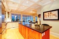 White large luxury kitchen with huge wood island.