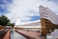 The white large reclining Buddha sculpture outdoor with beautiful sky in Wat Satu