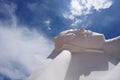 The white large reclining Buddha sculpture outdoor with beautiful sky in Wat Satu