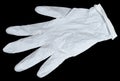 White latex medical glove on a black