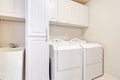 White laundry room with washer and dryer. Royalty Free Stock Photo