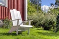 White lawn chair in summer garden Royalty Free Stock Photo