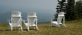 White lawn chairs with a view awaiting someone