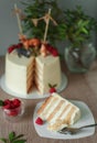 White, layered, multi-layer cake from biscuit smeared with cream, round shape, white cream inside
