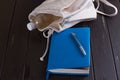 White leather backpack, blue notebook and pen