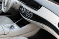 White leather interior of the luxury modern car. Leather comfortable white seats and multimedia. Steering wheel and dashboard. Royalty Free Stock Photo