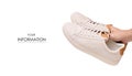 White leather male sneakers shoes on laces in hand pattern