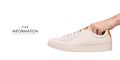 White leather male sneakers shoes on laces in hand pattern