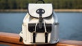 White leather school backpack on a pier on a lake