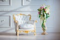 White leather vintage style chair in classical interior room with big window and spring flowers Royalty Free Stock Photo