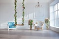 White leather vintage style chair in classical interior room with big window and spring flowers Royalty Free Stock Photo