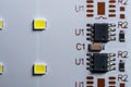 White LED panel with yellow light and microchip on background, top view, closeup Royalty Free Stock Photo