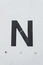 White letter n old metal background texture