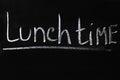 White white lettering on black chalkboard. Lunch time Royalty Free Stock Photo