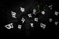 The white letters of the Bengali alphabet are Being visible in the black background.