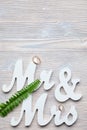White letters mr and vhk on a wooden background with a ring and a green branch. Top view. Copy place Royalty Free Stock Photo