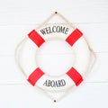 White Life buoy with welcome aboard on white wall Royalty Free Stock Photo