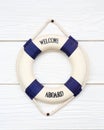White Life buoy with welcome aboard on white wall Royalty Free Stock Photo