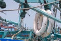 white life ring hanged against green mint pole of wooden fishing boat