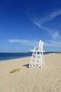 White lifeguard chair on empty sand beach with blue sky Royalty Free Stock Photo