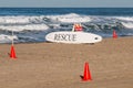White Lifeguard Rescue Board Surrounded By Orange Cones