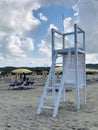 A white lifeguard tower on the beach .