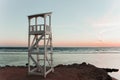 A white lifeguard tower near the tranquil waters