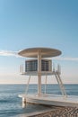 White lifeguard tower on a sandy beach with a calm sea Royalty Free Stock Photo